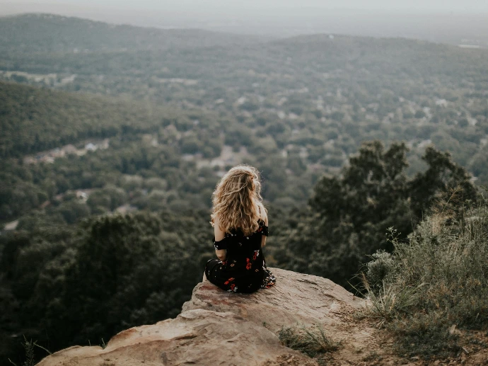 woman siting on cliff
